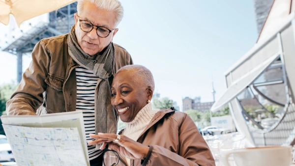 Two older people looking at a map.