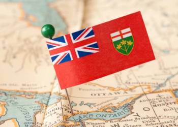 An Ontario flag pinned on a map.