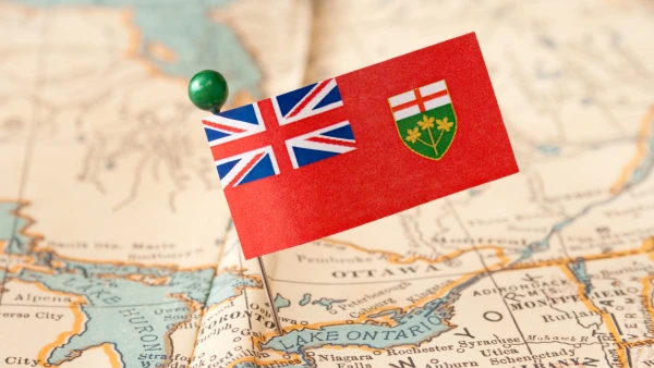 An Ontario flag pinned on a map.