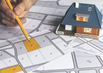 A model house on a map of land plots