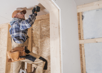 A man screwing in a screw.