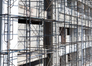 A pre-construction site with metal scaffolding.