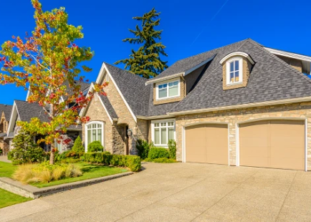 A home with a colorful tree in the front yard