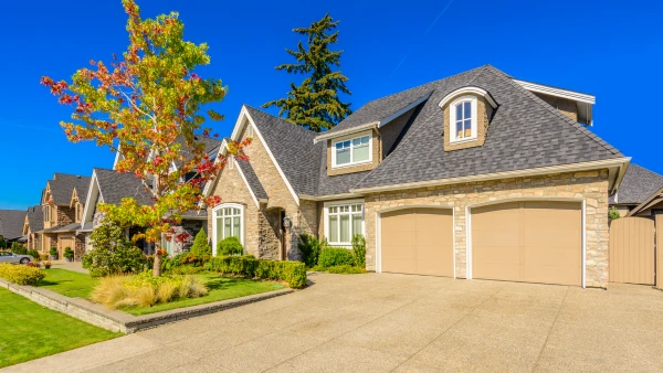 A home with a colorful tree in the front yard