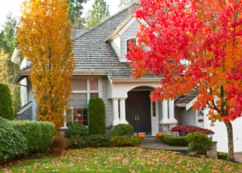 A home with colorful fall trees in front