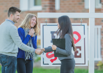 Homebuyers shaking hands with realtors.