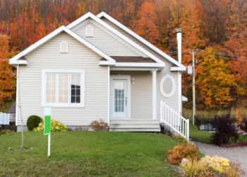 A home for sale with colorful fall leaves in the background