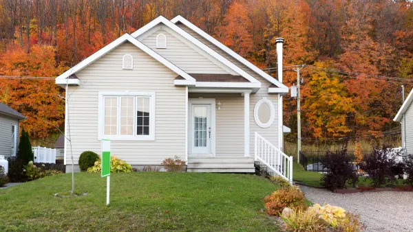 A home for sale with colorful fall leaves in the background