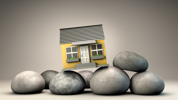 House with rocks under it.
