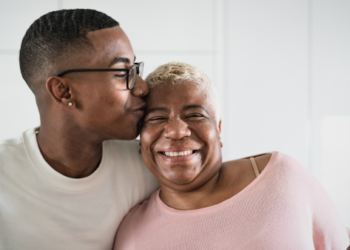 Adult child hugging their mother.