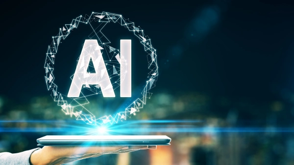 Someone holding a tablet with the letters AI emitting from the tablet