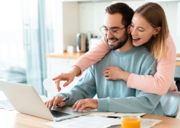 A happy couple looking at a computer screen