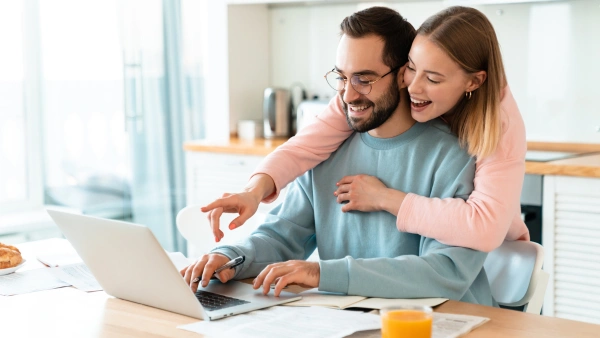 A happy couple looking at a computer screen