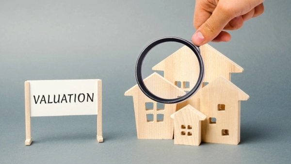 Someone holds an investigative magnifier over a home