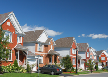 A row of houses on a sunny street.