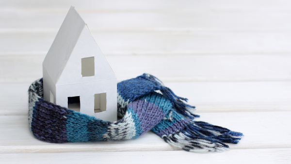 A toy house with a scarf wrapped around it.
