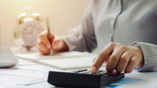 Someone using a calculator and filing taxes