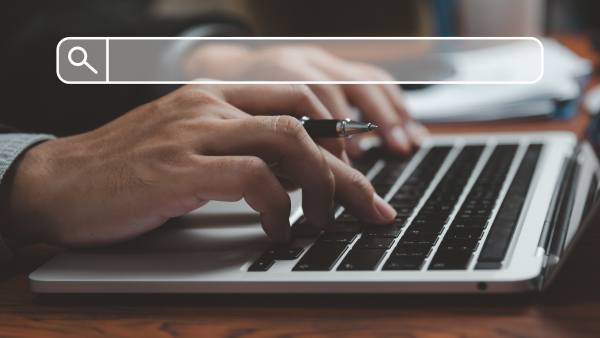 A person searching on a laptop.