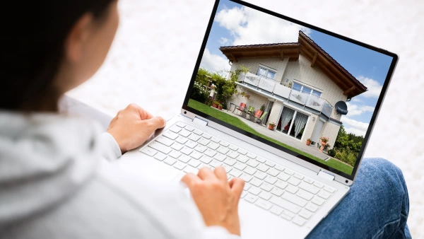Someone searching for a home on a laptop
