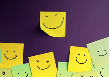 Sticky notes on a wall with smiley faces