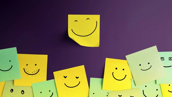 Sticky notes on a wall with smiley faces