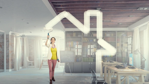 Person painting the outline of a home.