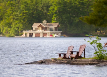 Muskoka chairs on a lake