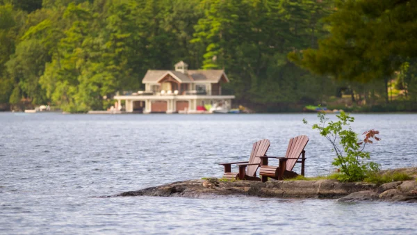 Muskoka chairs on a lake