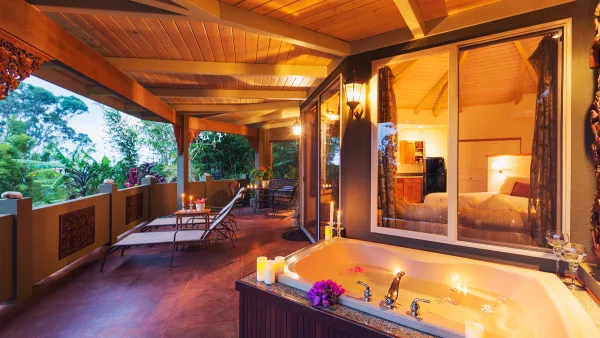 Cabin with a hot tub and lights.