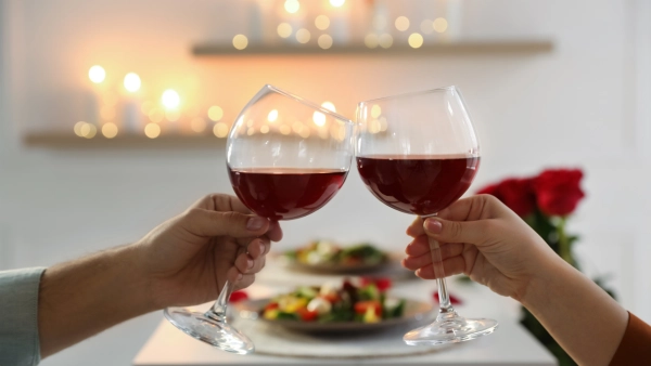 Two glasses of wine cheering together.