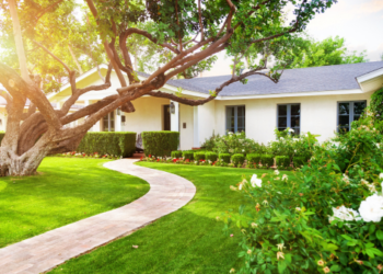 A home with shrubs and trees.