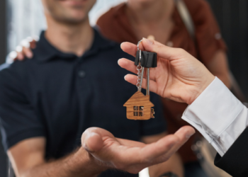 A man being handed house keys.