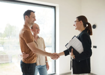 Relator shaking hands with young couple