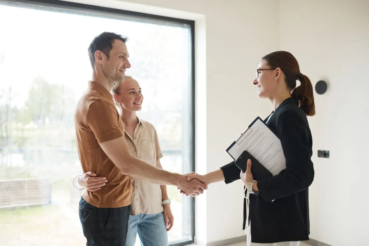 Relator shaking hands with young couple