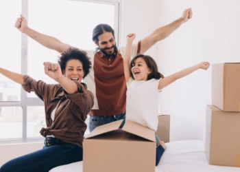 A happy family with moving boxes