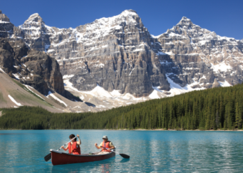 Two people kayaking in the mountains.