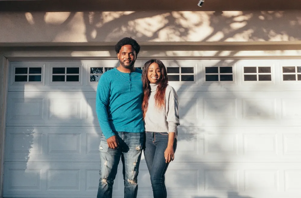 couple in front of garage