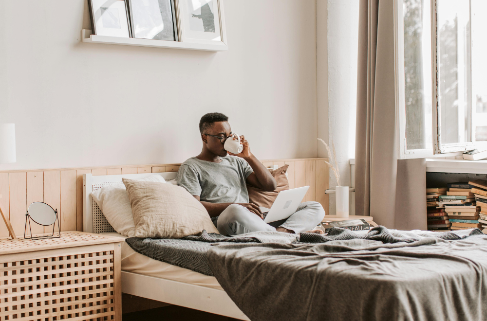 Person drinking coffee in a bed