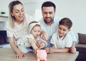 A family putting money in a piggy bank