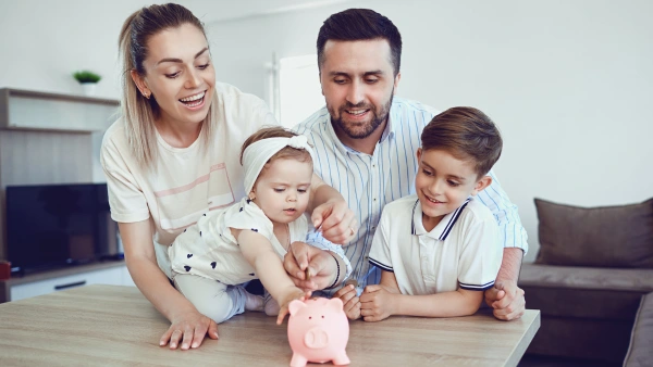 A family putting money in a piggy bank