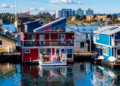 Red and blue waterfront boat homes in Canada.