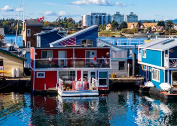 Red and blue waterfront boat homes in Canada.