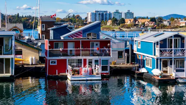 Red and blue waterfront boat homes in Canada.