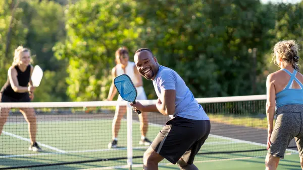 Smiling pickleball player and friends
