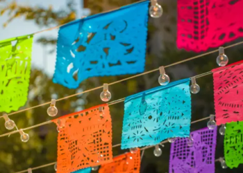 Traditional colourful paper mexican banner with string lights