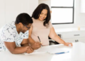Couple signing papers to a new home in kitchen