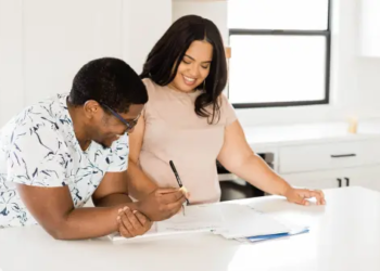 Couple signing papers to a new home in kitchen