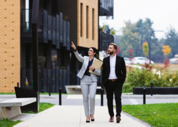 A real estate agent shows a client a property