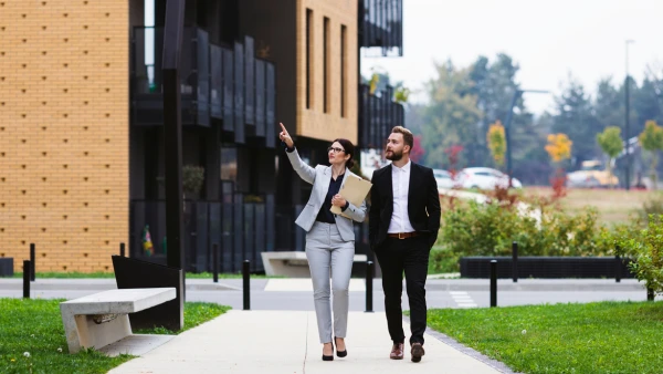 A real estate agent shows a client a property