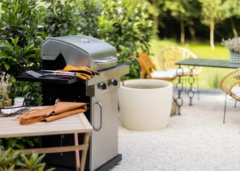 A picture of a backyard with a grill